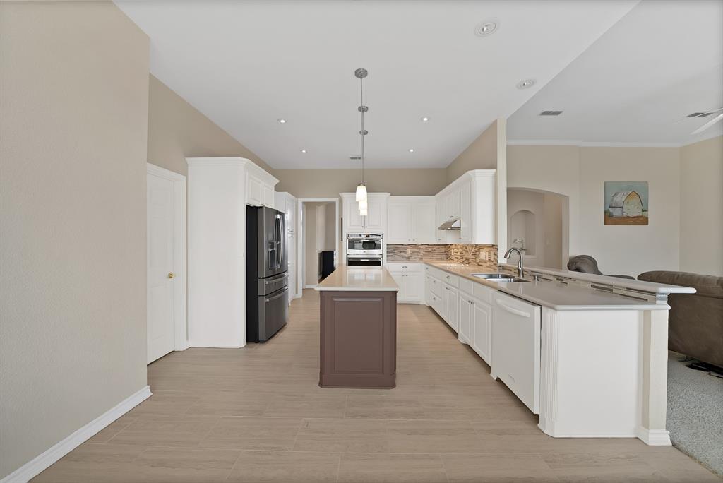 11692 Foutch Road Pilot Point, TX 76258 - Photo 12 of 40 a kitchen with a sink a counter top space and stainless steel appliances