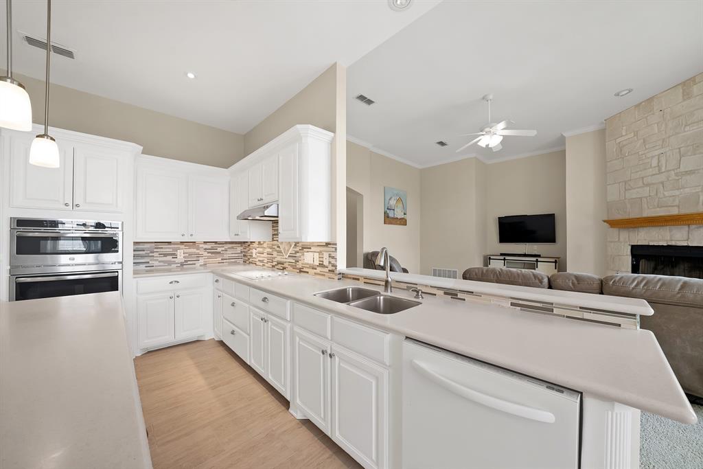 11692 Foutch Road Pilot Point, TX 76258 - Photo 13 of 40 a kitchen with a sink stove and cabinets