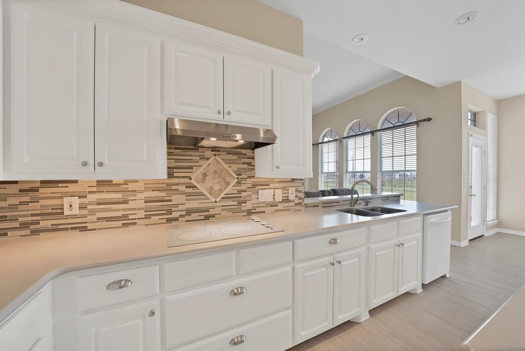 11692 Foutch Road Pilot Point, TX 76258 - Photo 16 of 40 a kitchen with white cabinets and sink