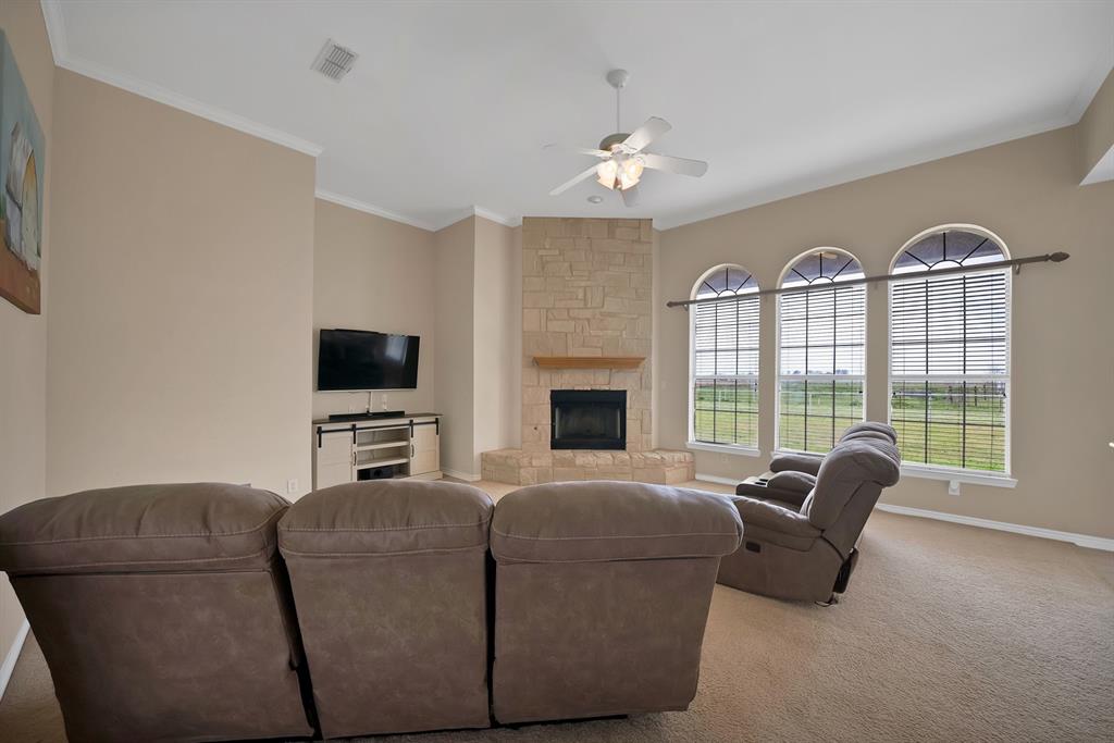 11692 Foutch Road Pilot Point, TX 76258 - Photo 19 of 40 a living room with furniture a fireplace and a flat screen tv
