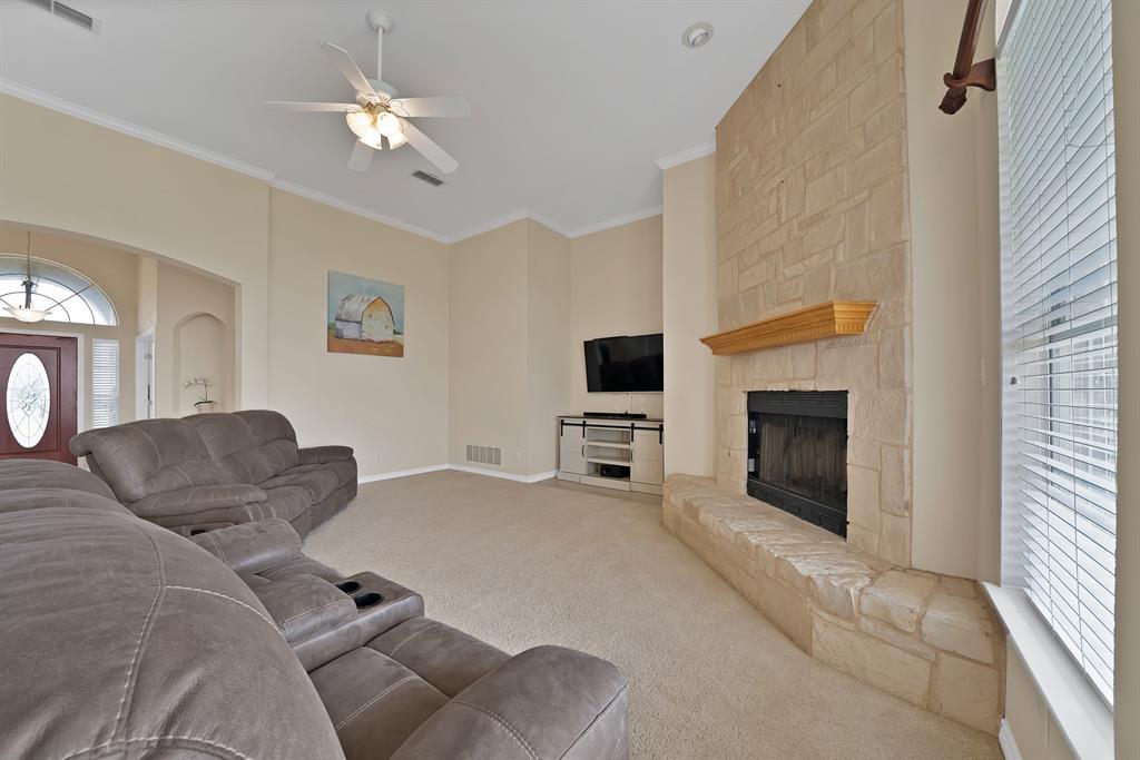 11692 Foutch Road Pilot Point, TX 76258 - Photo 20 of 40 a living room with furniture a fireplace and a flat screen tv