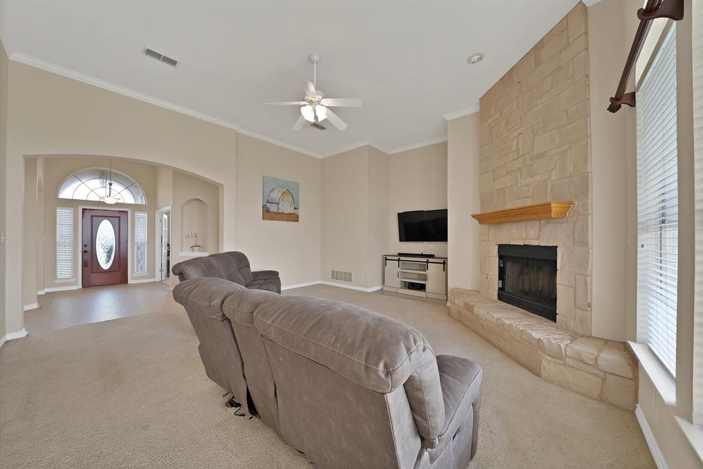 11692 Foutch Road Pilot Point, TX 76258 - Photo 21 of 40 a living room with furniture a fireplace and a flat screen tv