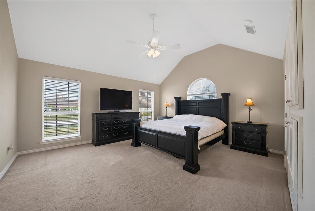 11692 Foutch Road Pilot Point, TX 76258 - Photo 26 of 40 a spacious bedroom with a bed and a television