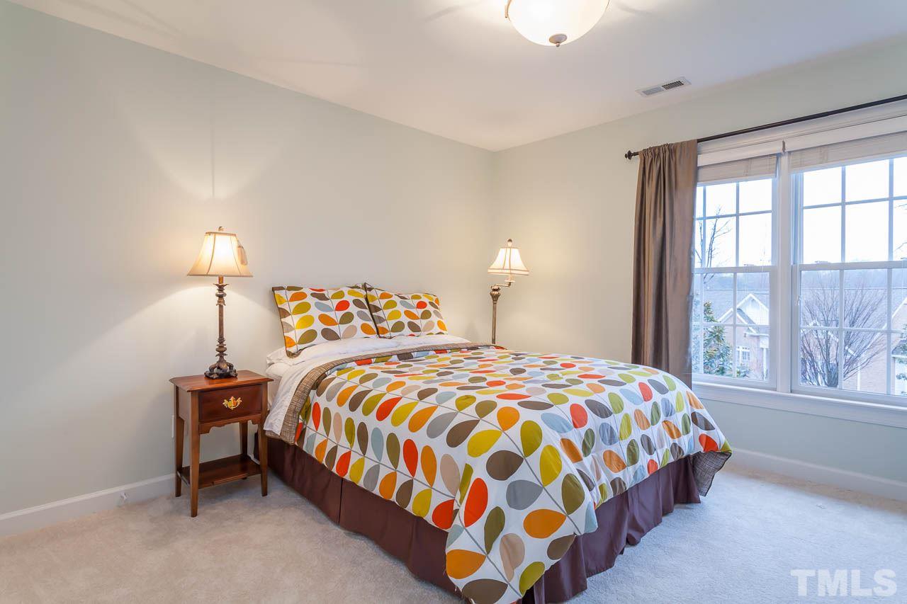 5404 Killarney Hope Drive Raleigh, NC 27613 - Photo 13 of 22 a bedroom with a bed and a lamp next to a window