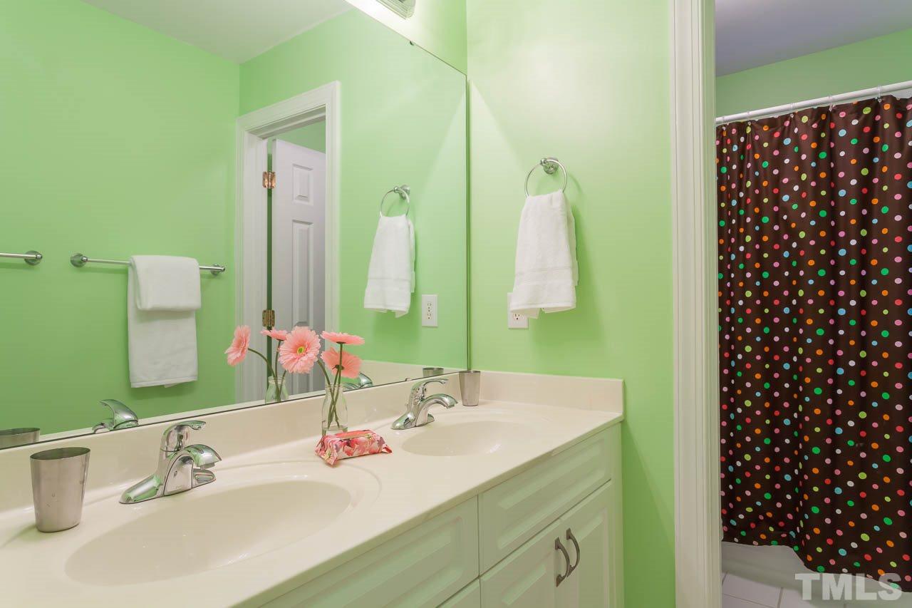 5404 Killarney Hope Drive Raleigh, NC 27613 - Photo 14 of 22 a bathroom with a sink and a mirror