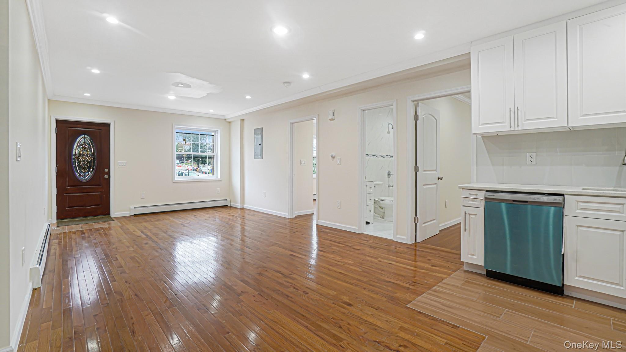 85-02 165th Street Queens, NY 11432 - Photo 14 of 36 Foyer featuring light wood finished floors, ornamental molding, recessed lighting, and a baseboard heating unit