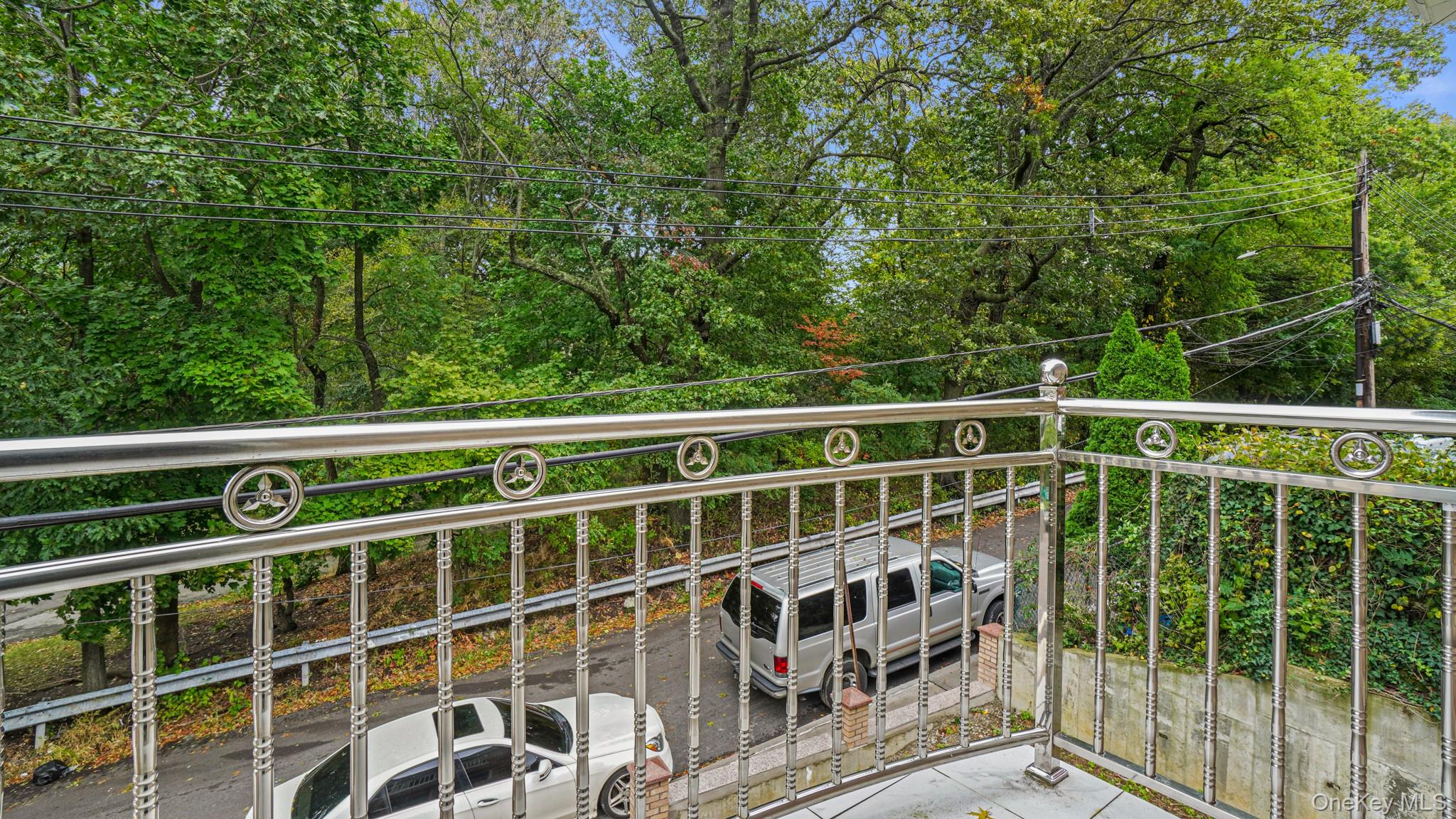 85-02 165th Street Queens, NY 11432 - Photo 25 of 36 Balcony featuring view of wooded area