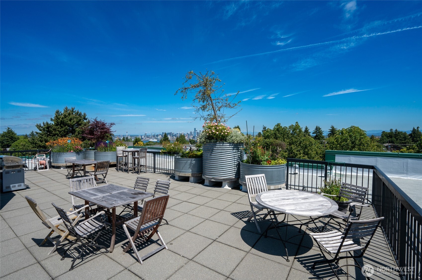 2331 42nd Avenue Southwest, Unit 209 Seattle, WA 98116 - Photo 18 of 21 a view of a patio with a table and chairs
