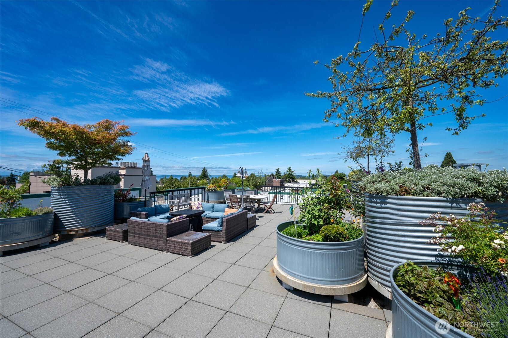 2331 42nd Avenue Southwest, Unit 209 Seattle, WA 98116 - Photo 20 of 21 a view of a terrace with furniture and potted plants