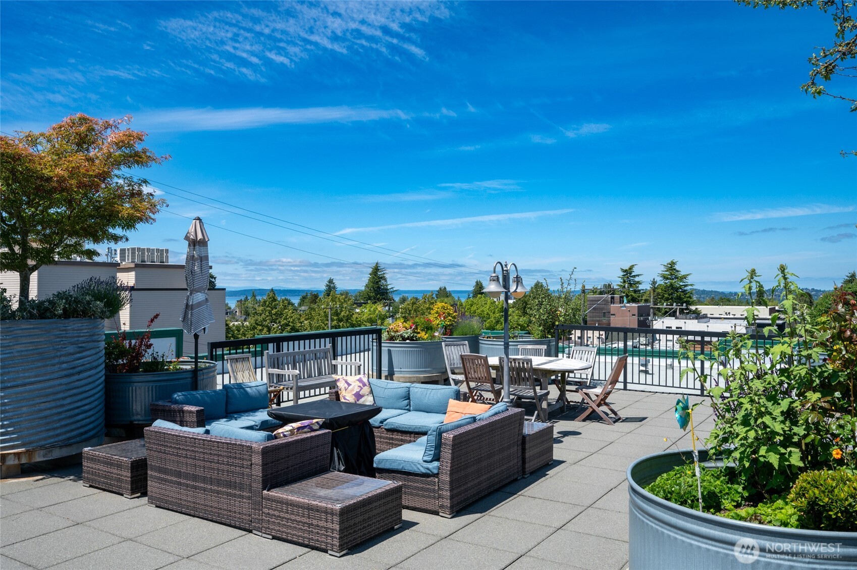 2331 42nd Avenue Southwest, Unit 209 Seattle, WA 98116 - Photo 21 of 21 a view of a terrace with couches and potted plants