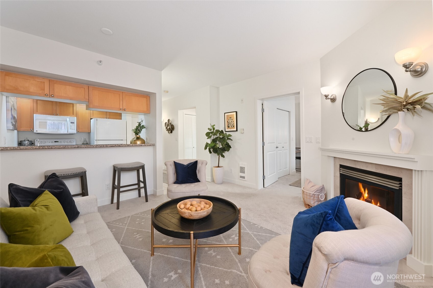 2331 42nd Avenue Southwest, Unit 209 Seattle, WA 98116 - Photo 5 of 21 a living room with furniture a rug and a fireplace