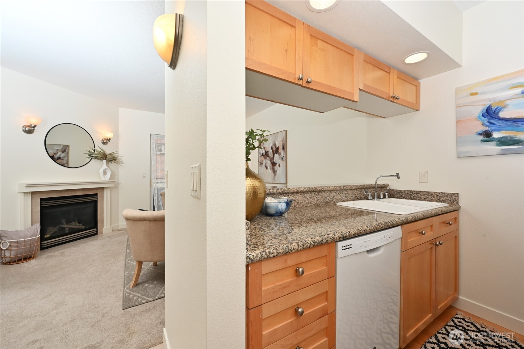2331 42nd Avenue Southwest, Unit 209 Seattle, WA 98116 - Photo 7 of 21 a bathroom with a granite countertop sink and a mirror