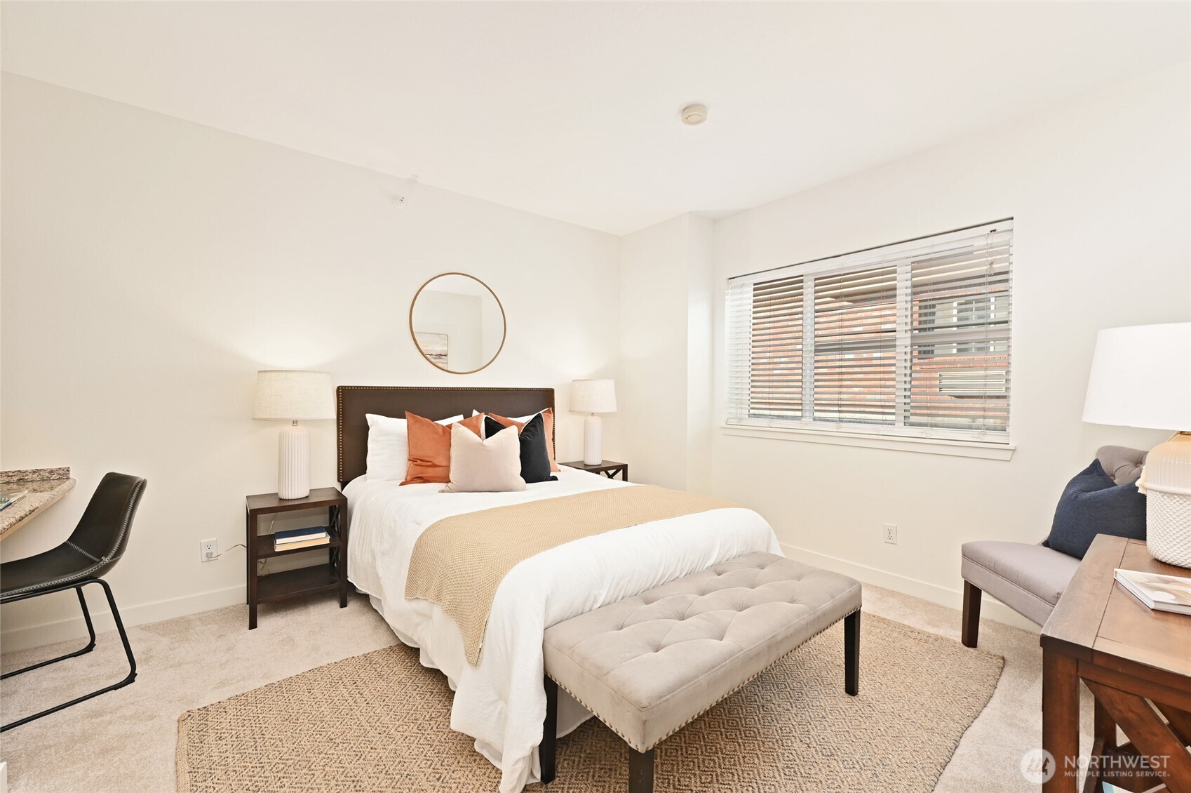 2331 42nd Avenue Southwest, Unit 209 Seattle, WA 98116 - Photo 9 of 21 a bedroom with a bed a chair and a window