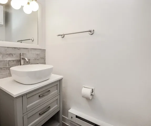 a bathroom with a sink toilet and mirror