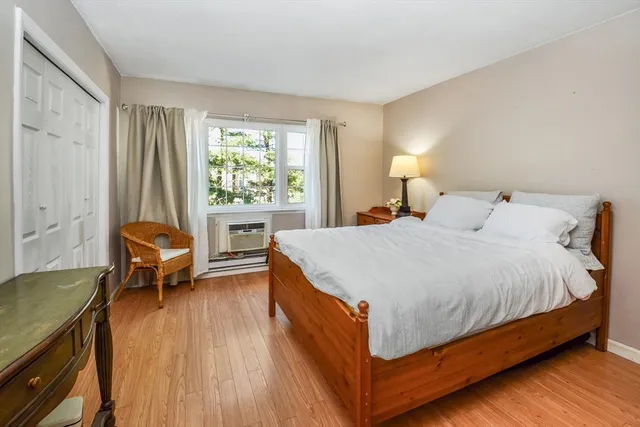 a bed room with a bed and a chair