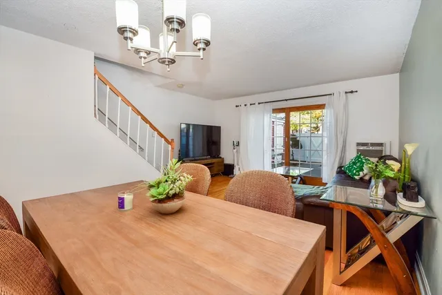 a view of a dining room with furniture and a potted plant