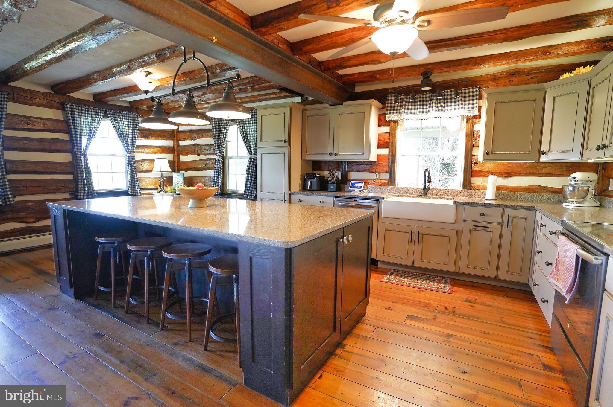 2215 Centennial Road Hanover, PA 17331 - Photo 11 of 60 a large kitchen with stainless steel appliances granite countertop a sink a counter space and wooden floors
