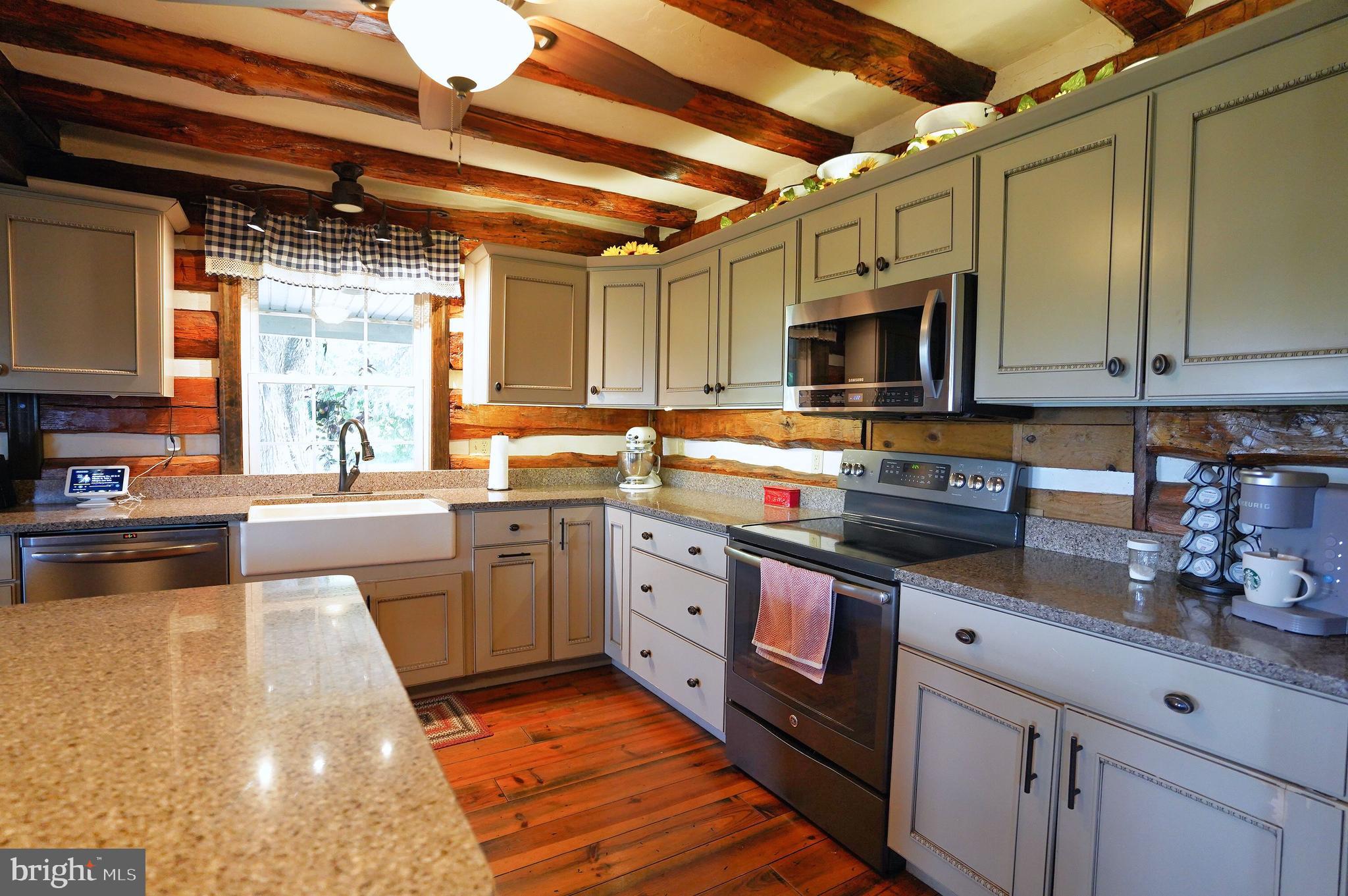 2215 Centennial Road Hanover, PA 17331 - Photo 12 of 60 a kitchen with stainless steel appliances granite countertop a sink a stove top oven a counter space and cabinets
