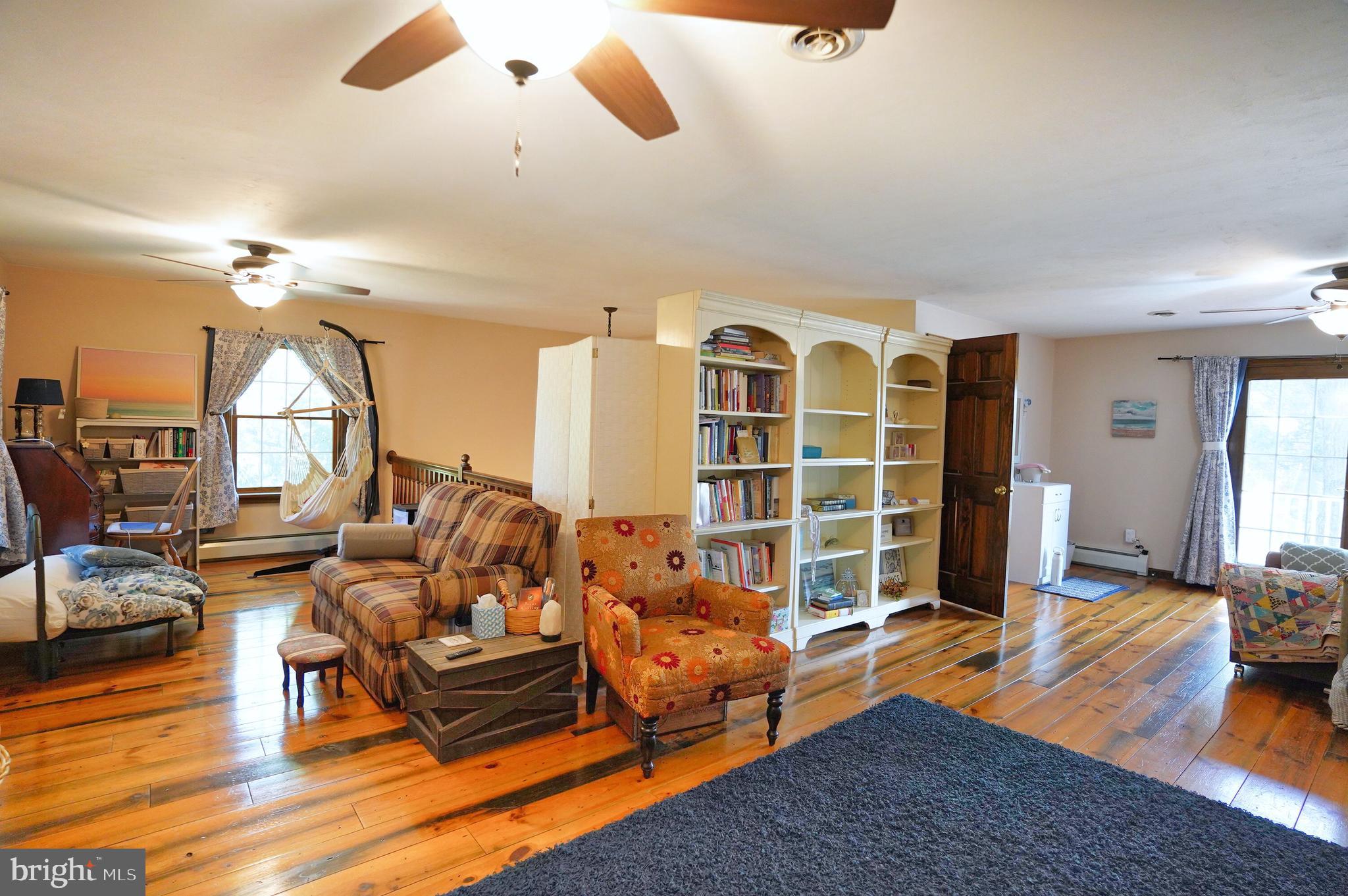 2215 Centennial Road Hanover, PA 17331 - Photo 30 of 60 a living room with furniture gym equipment and a large window