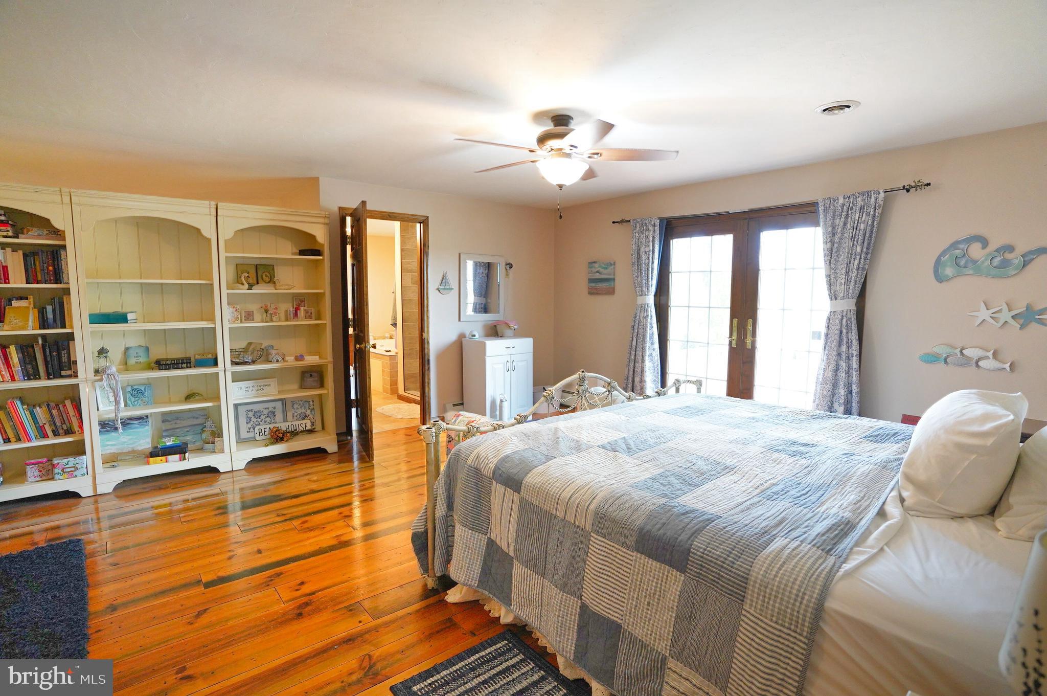 2215 Centennial Road Hanover, PA 17331 - Photo 36 of 60 a spacious bedroom with a bed and a chandelier