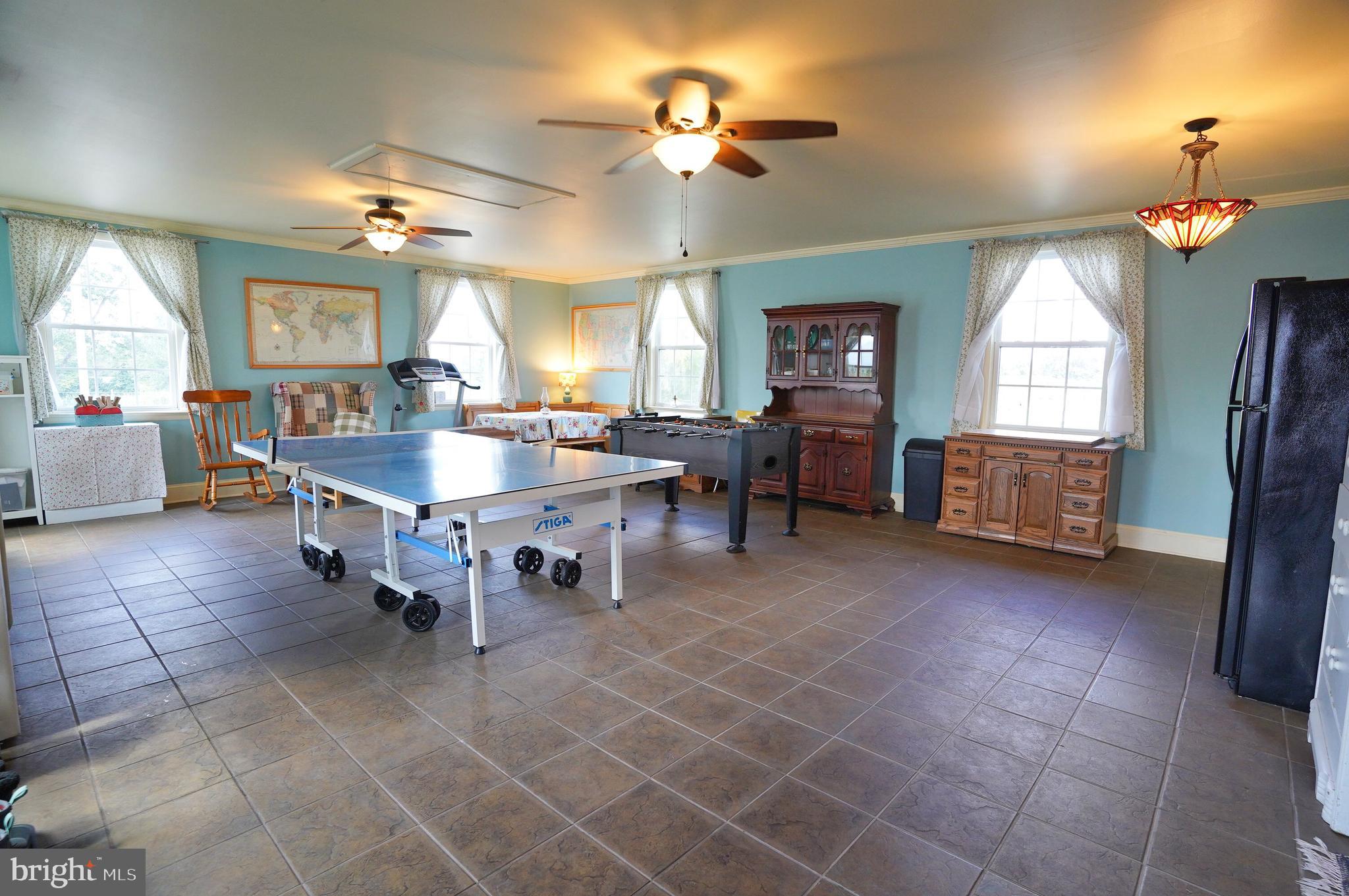 2215 Centennial Road Hanover, PA 17331 - Photo 46 of 60 a living room with couches a dining table and paintings on the wall