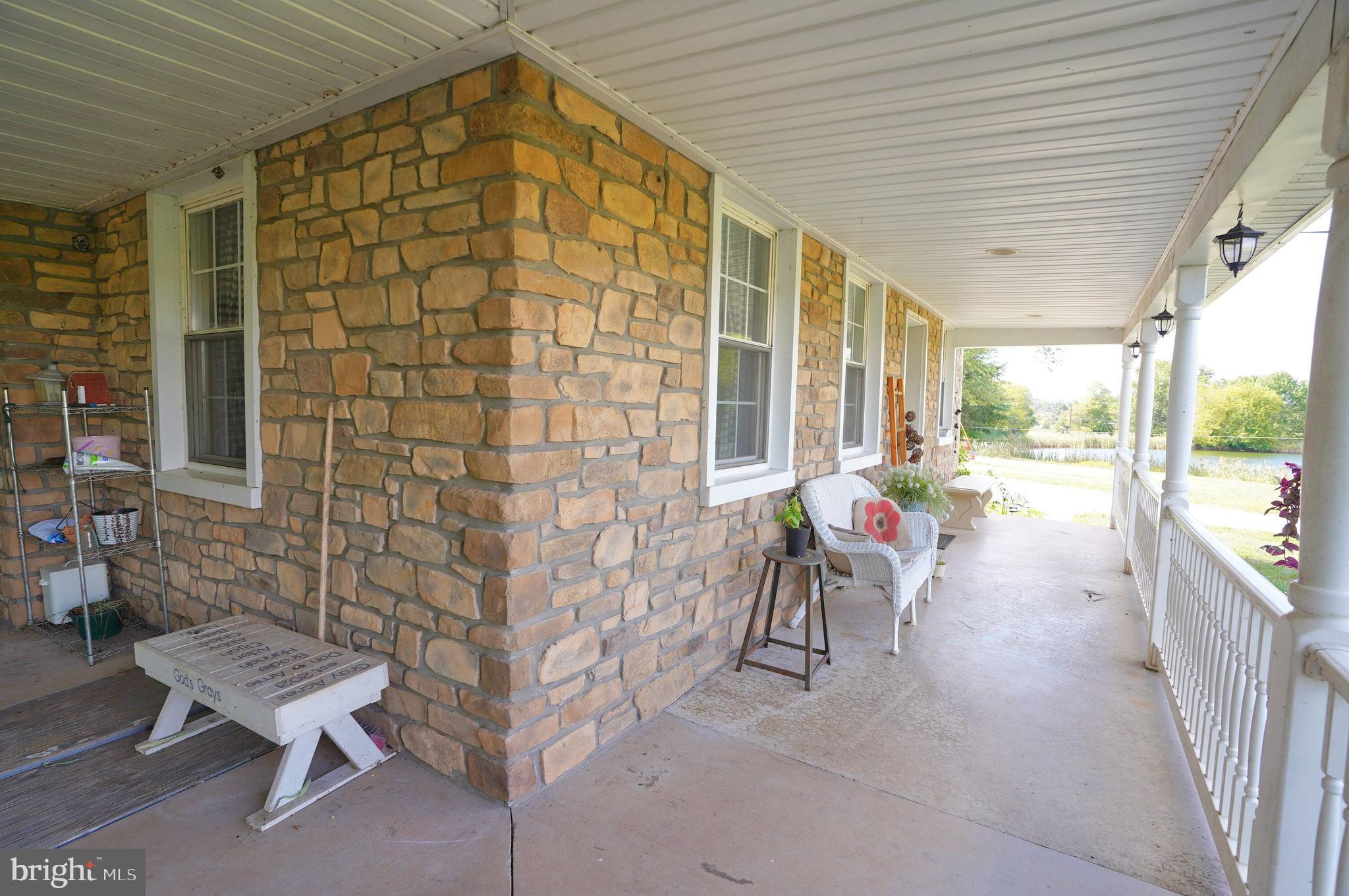 2215 Centennial Road Hanover, PA 17331 - Photo 5 of 60 a view of a patio with a table and chairs and potted plants
