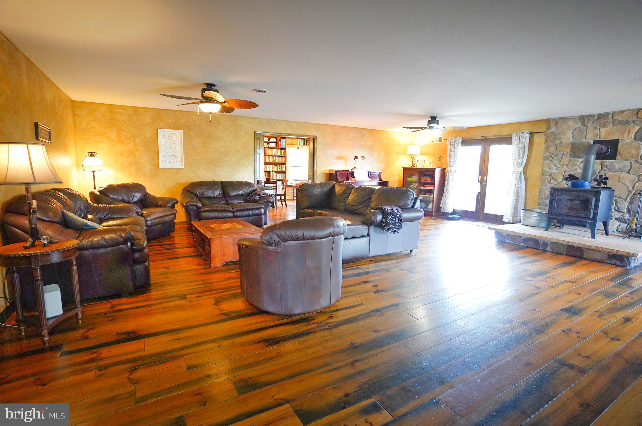 2215 Centennial Road Hanover, PA 17331 - Photo 6 of 60 a living room with couches kitchen view and large window with wooden floor