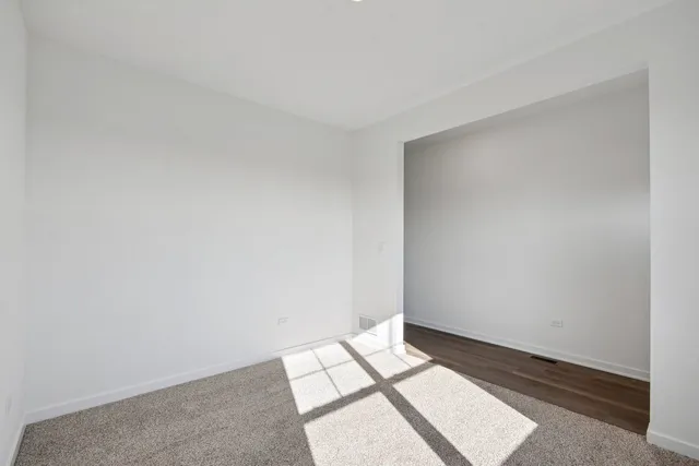 a view of an empty room and wooden floor