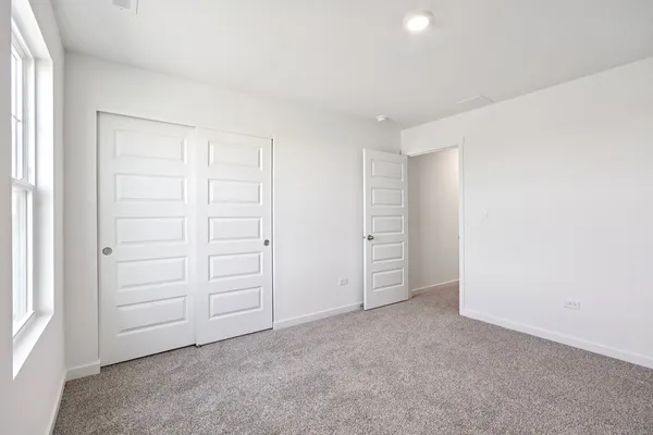 a living room with furniture a flat screen tv and a large window
