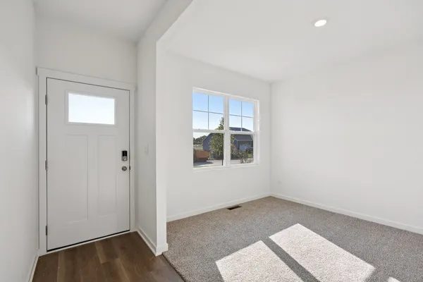 a view of a room with wooden floor