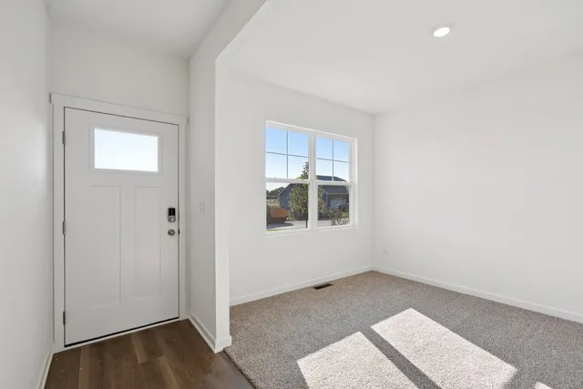 a view of a room with wooden floor