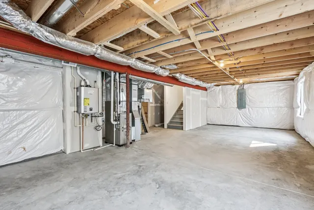 a kitchen with a table chairs refrigerator and microwave
