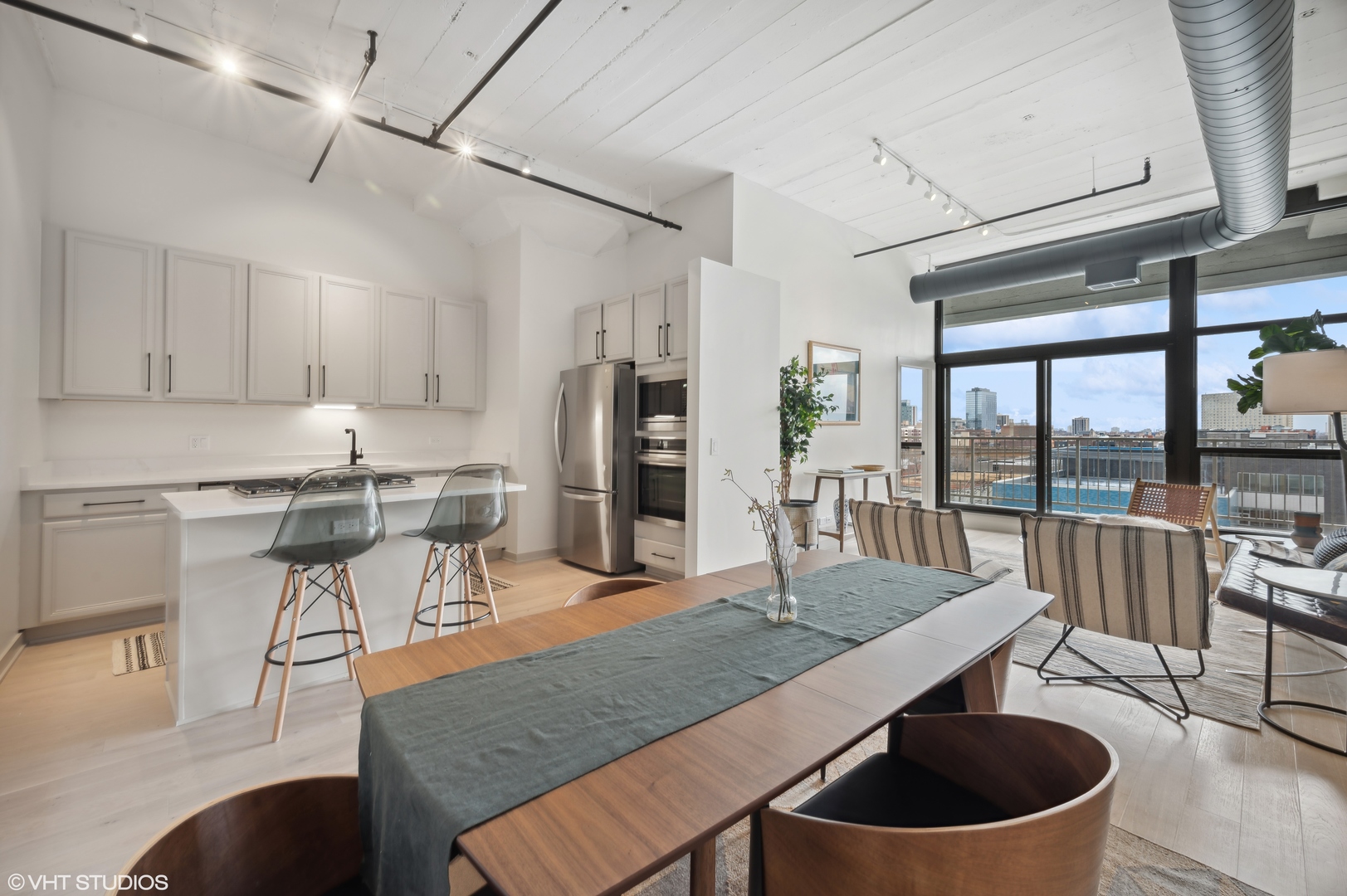 1530 South State Street, Unit 628 Chicago, IL 60605 - Photo 4 of 30 a living room with stainless steel appliances granite countertop a table chairs and a view of living room