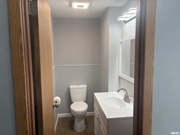 a white toilet sitting next to a bathroom sink