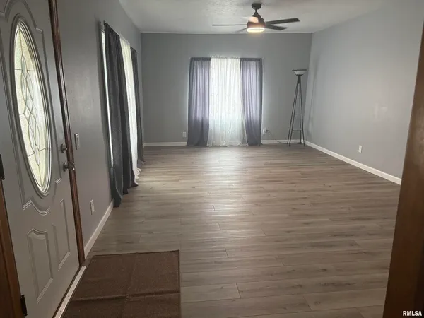 wooden floor in an empty room with a mirror