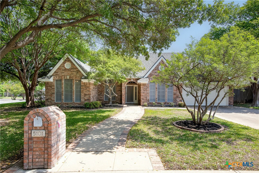a front view of a house with a yard garage and outdoor seating