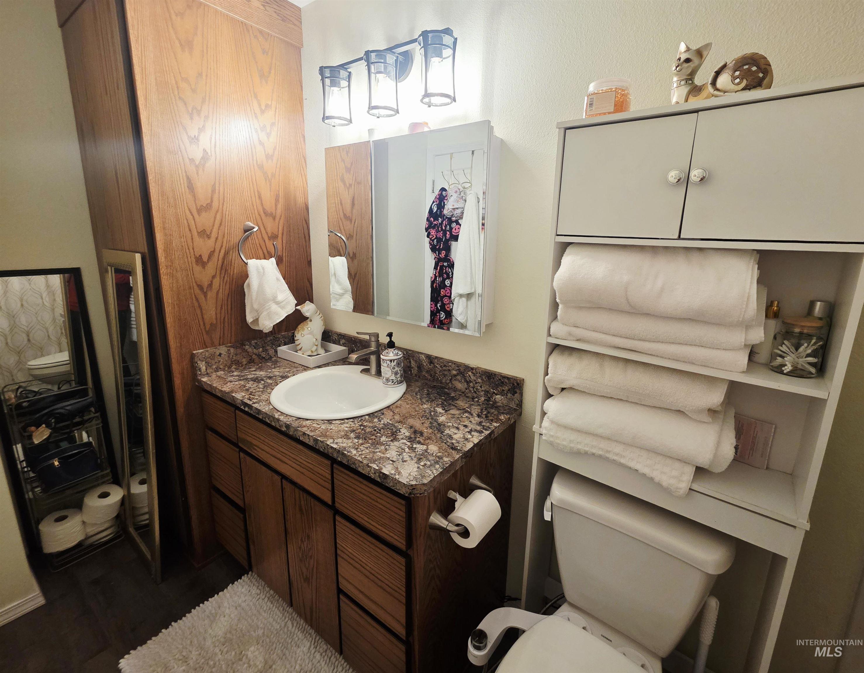 409 8th Street Clarkston, WA 99403 - Photo 7 of 23 Bathroom vanity with wood-finish cabinetry and a single oval basin