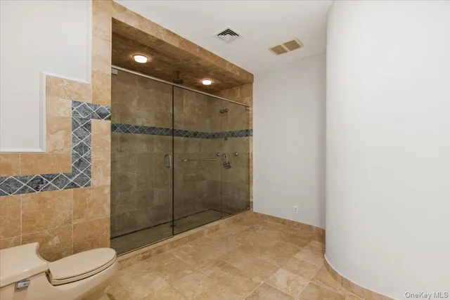 a bathroom with a shower and toilet