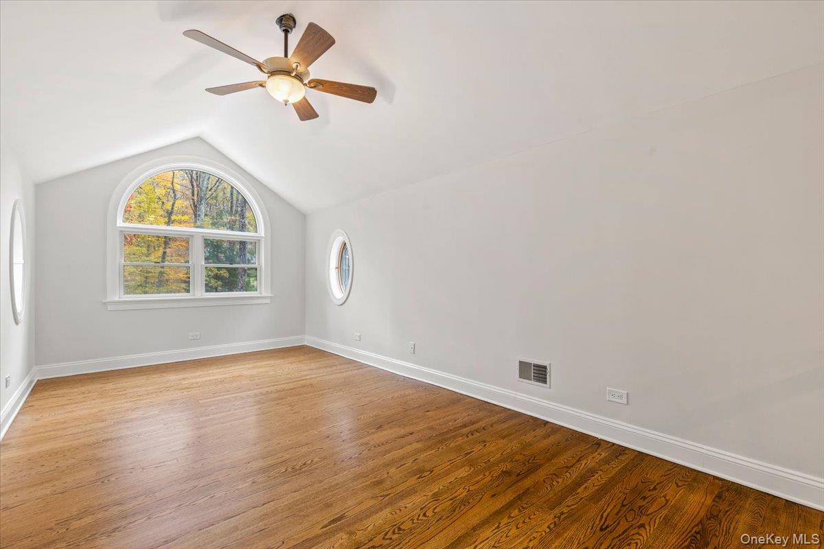 110 Oliver Road Bedford, NY 10506 - Photo 19 of 33 an empty room with wooden floor fan and windows