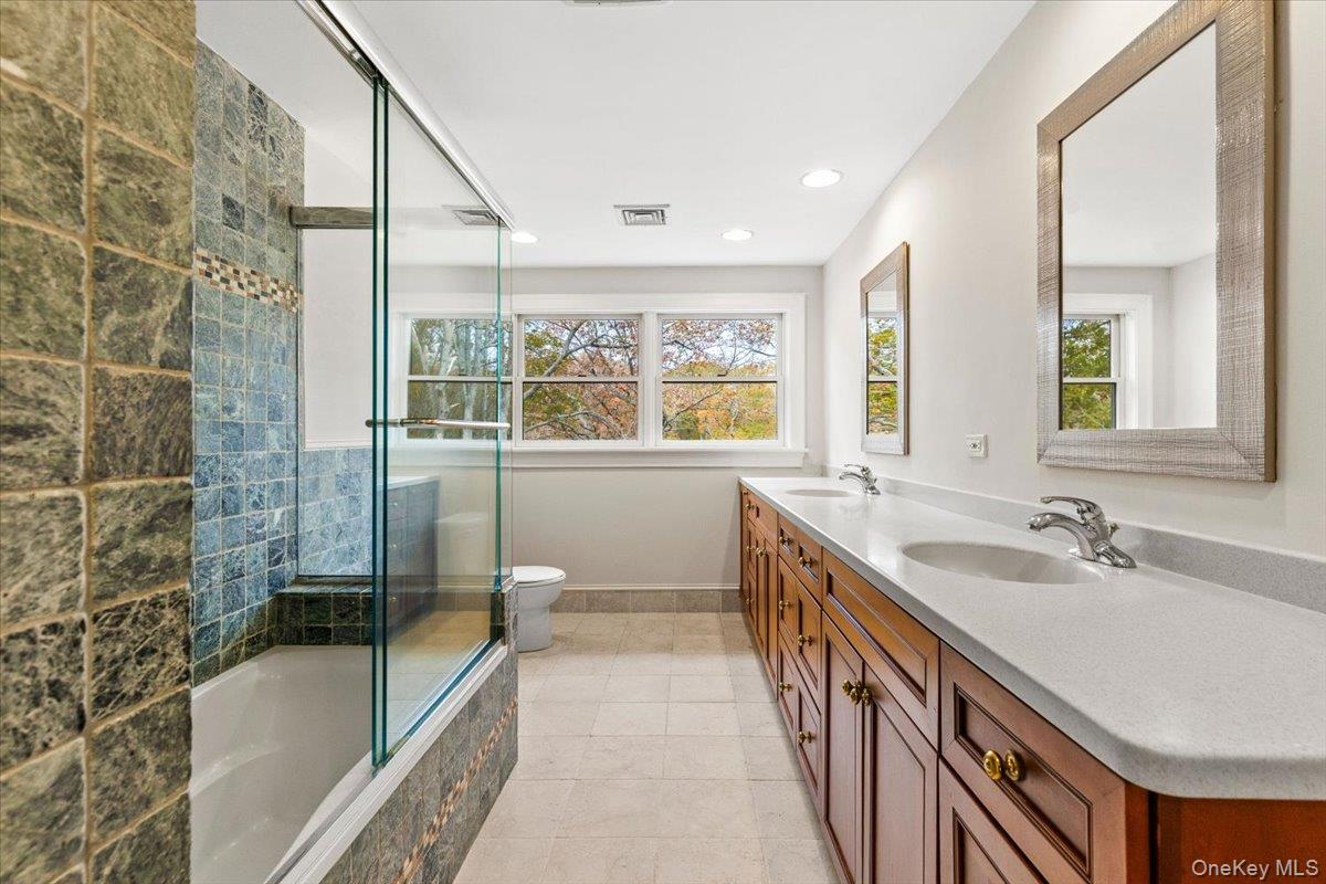 110 Oliver Road Bedford, NY 10506 - Photo 21 of 33 a bathroom with a tub sink and mirror