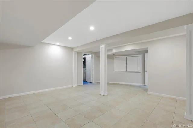 an empty room with closet and a window