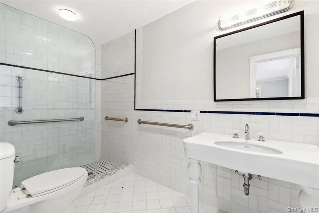 a bathroom with a toilet a sink and mirror