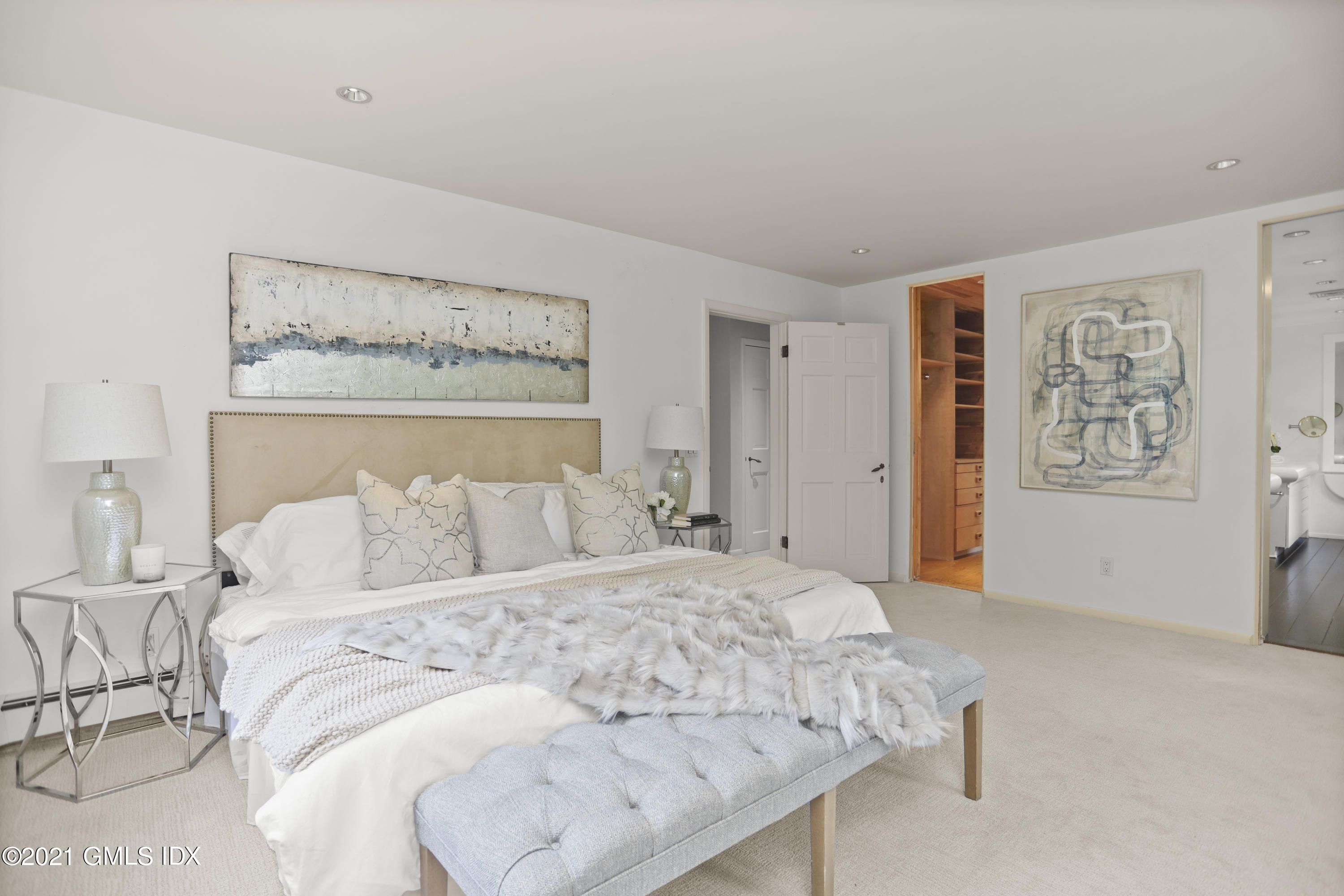 12 Guinea Road Greenwich, CT 06830 - Photo 12 of 29 a bedroom with a large bed and painting on the wall