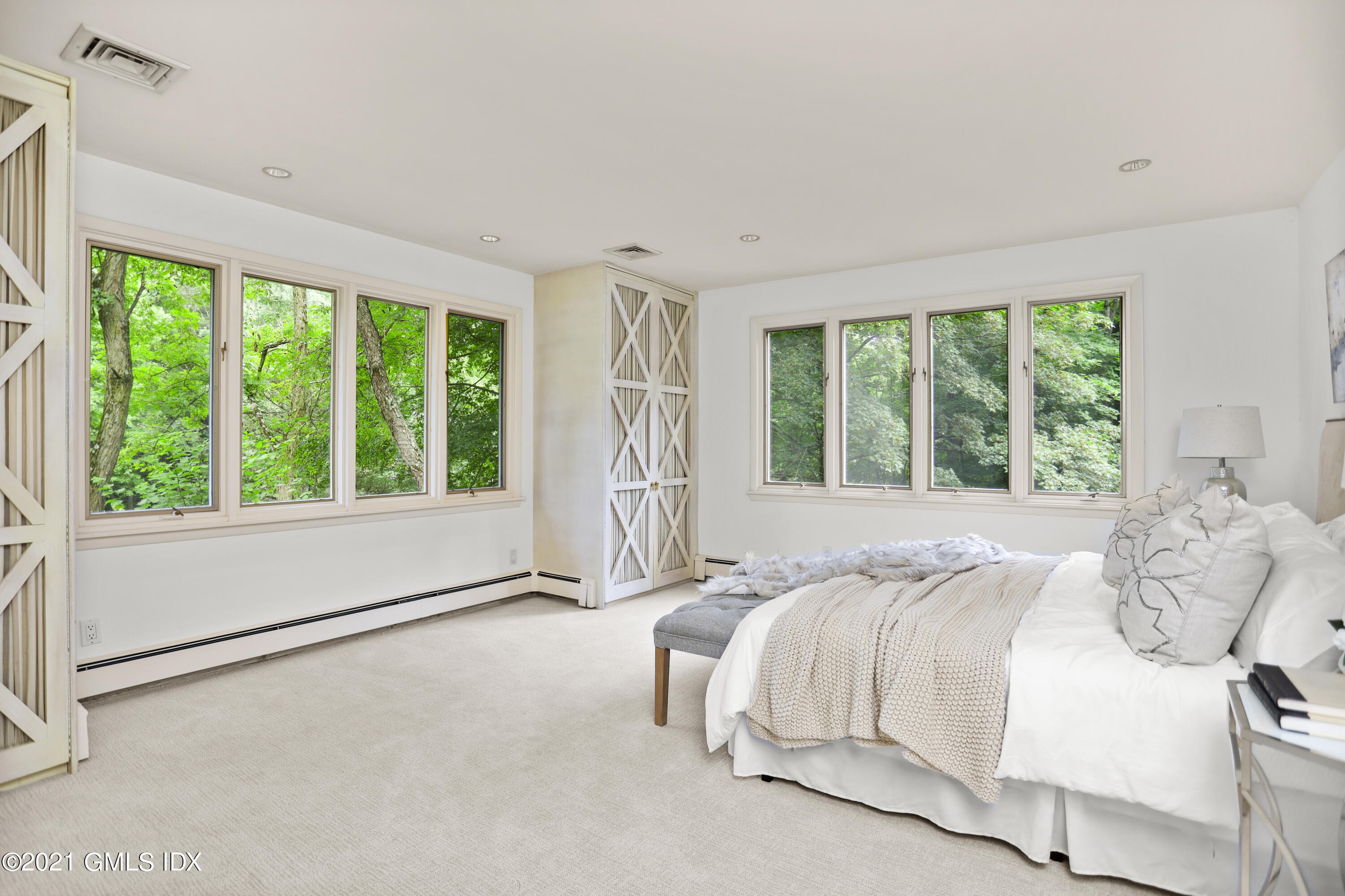 12 Guinea Road Greenwich, CT 06830 - Photo 13 of 29 a bed sitting in a spacious bedroom next to a window