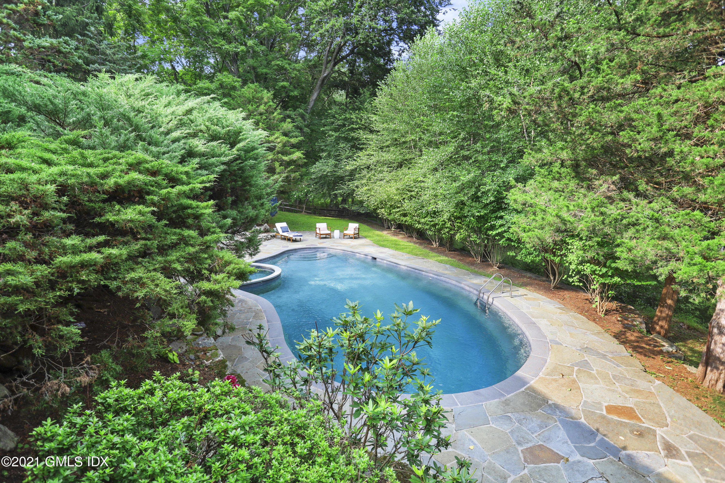 12 Guinea Road Greenwich, CT 06830 - Photo 18 of 29 a view of a garden with a fountain
