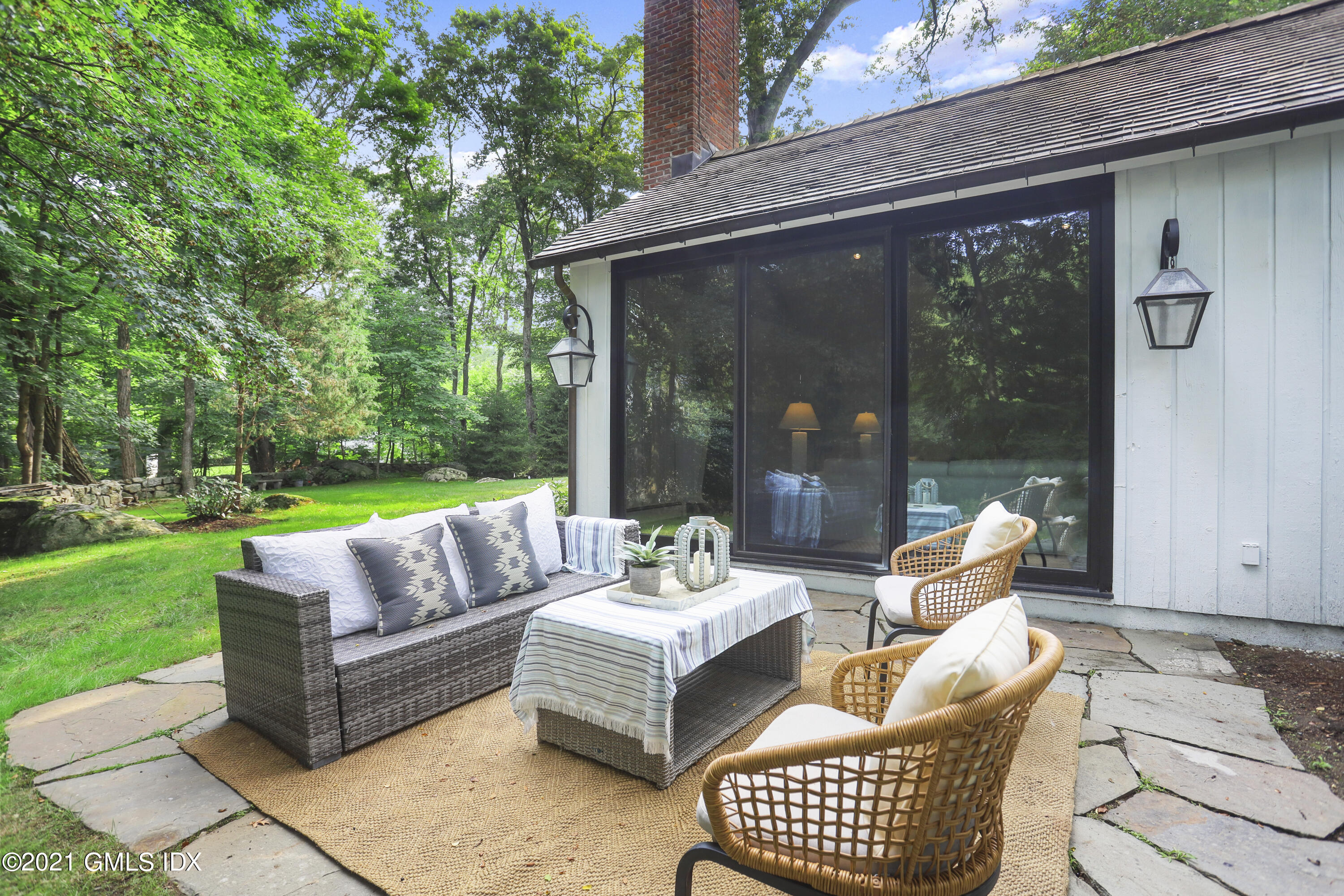 12 Guinea Road Greenwich, CT 06830 - Photo 20 of 29 a view of a patio with couches and a table and chairs