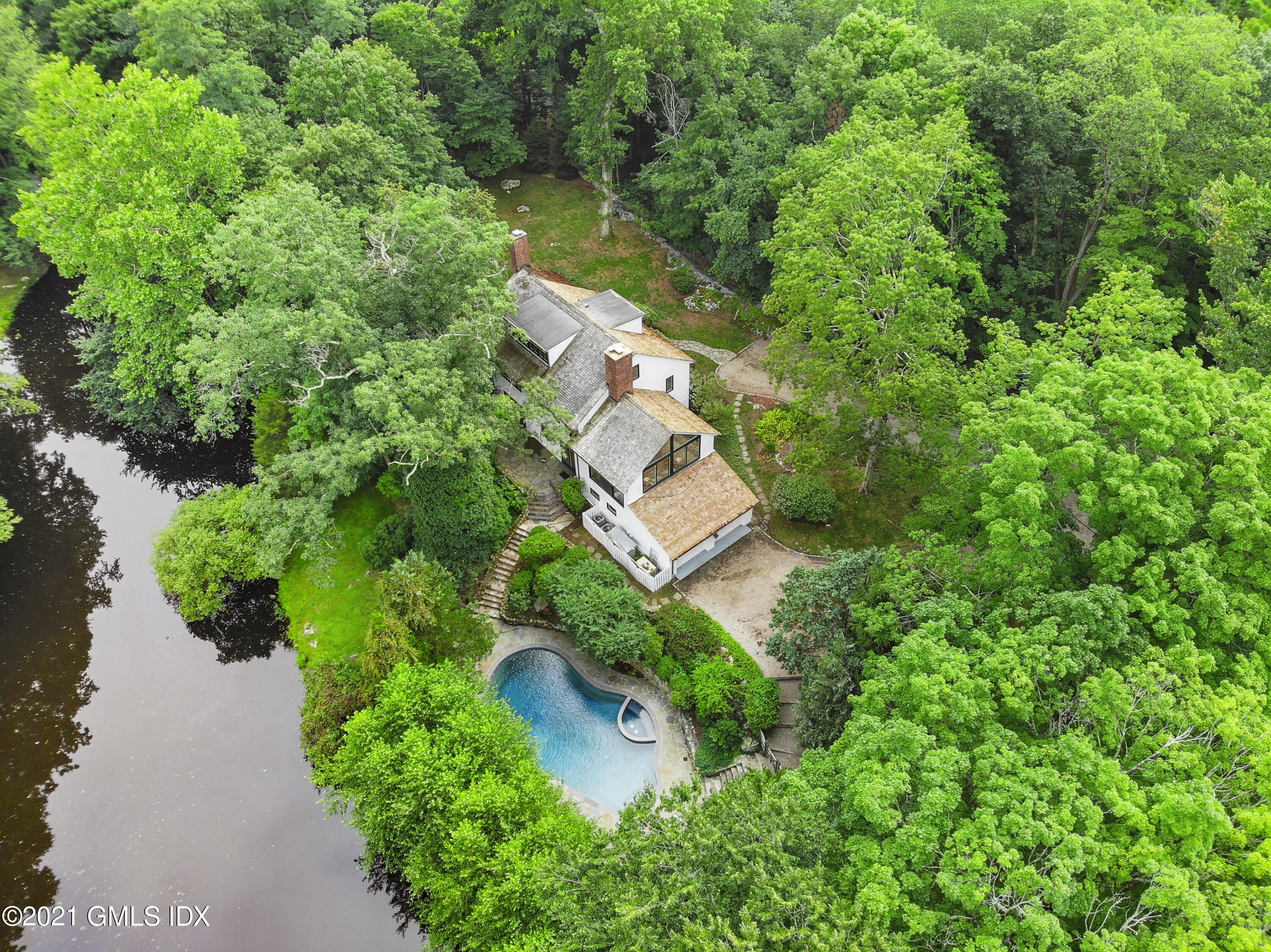12 Guinea Road Greenwich, CT 06830 - Photo 22 of 29 an aerial view of residential house with outdoor space and trees all around