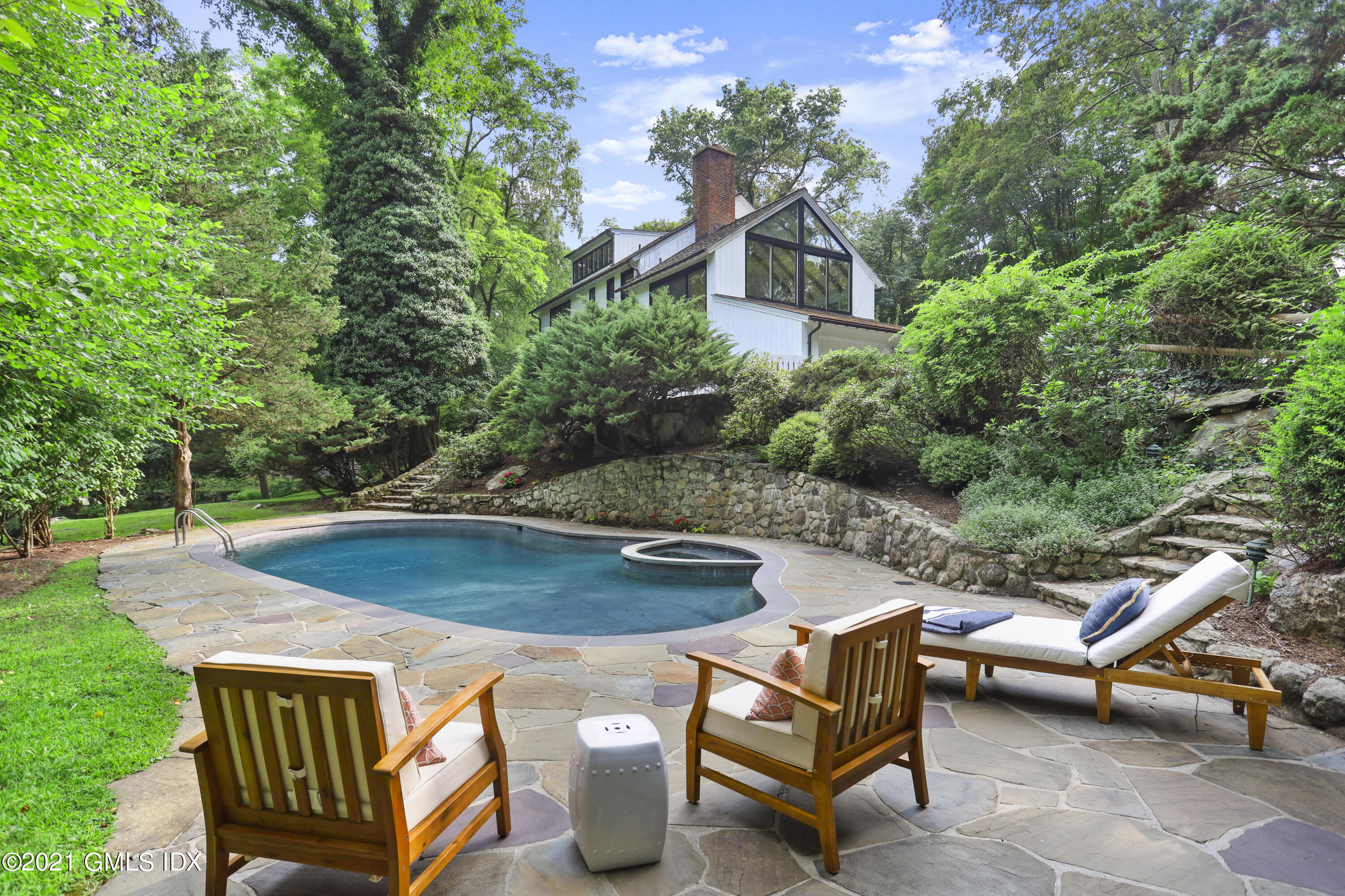 12 Guinea Road Greenwich, CT 06830 - Photo 3 of 29 an aerial view of a swimming pool with a patio