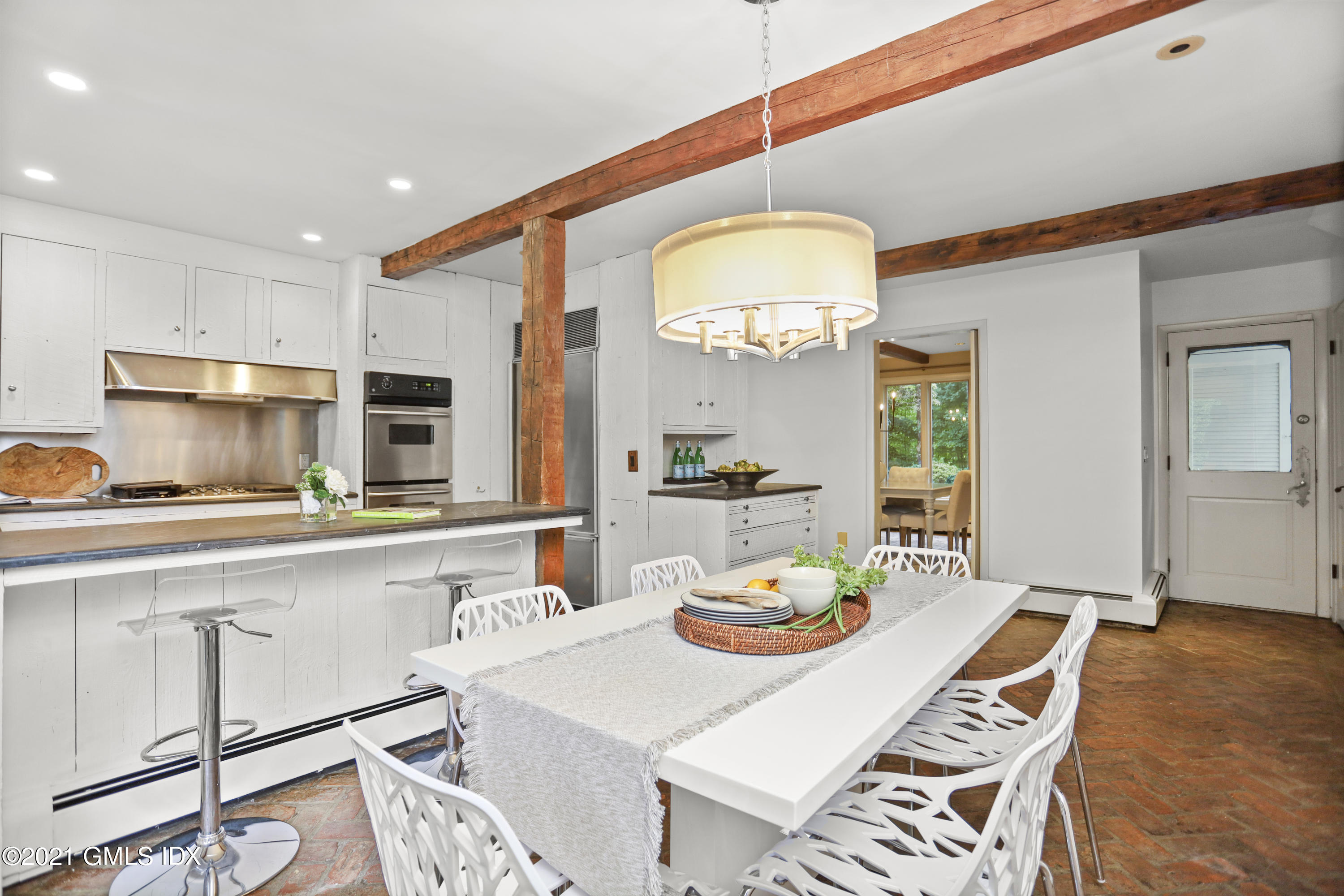 12 Guinea Road Greenwich, CT 06830 - Photo 9 of 29 a open dining room with stainless steel appliances a table and chairs with kitchen view