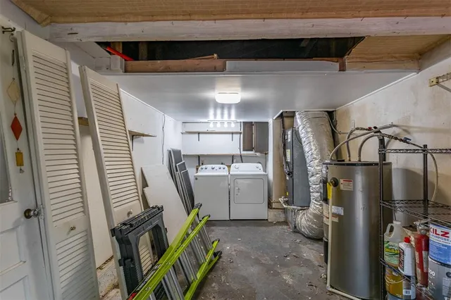 a storage room with water heater and refrigerator